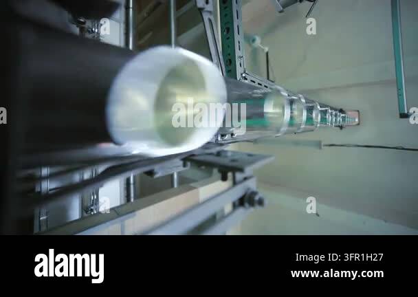 Glass bottles moving conveyor belt dairy plant. Low angle automated ...