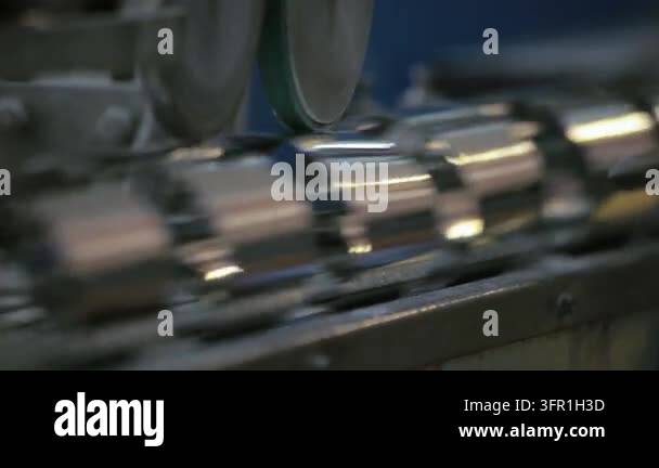 Shiny metal cylinders moving conveyor line modern factory. Close up ...