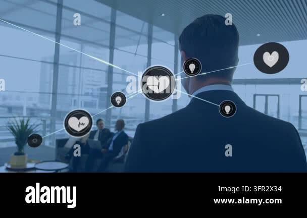 Man in suit standing at window, heart icon appearing connecting idea ...