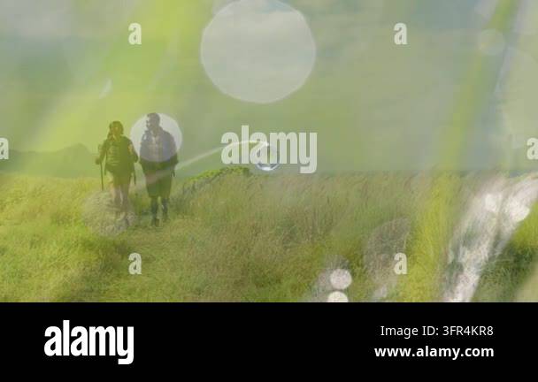 Overlay Html Over Video Two hikers walking narrow meadow path drawing them forward, bokeh ...