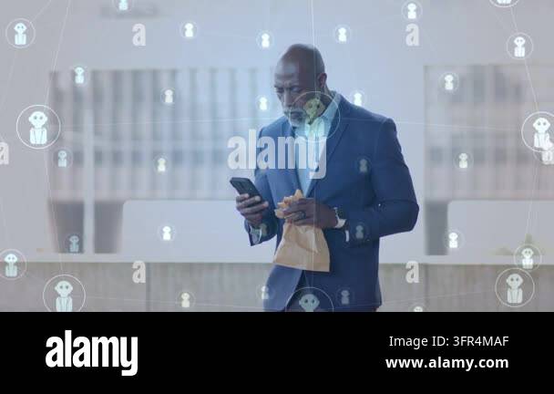 Exec opening bag in atrium, scrolling phone, network icons floating ...