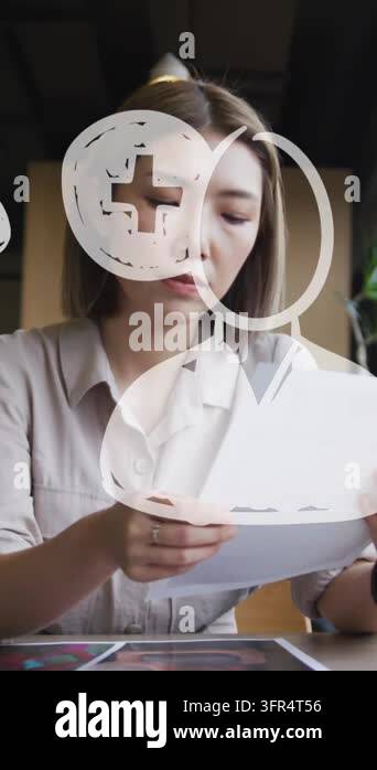 Animation of media icons over asian businesswoman holding document ...