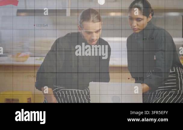 Two chefs reviewing sales on laptop in kitchen, watching as animated ...