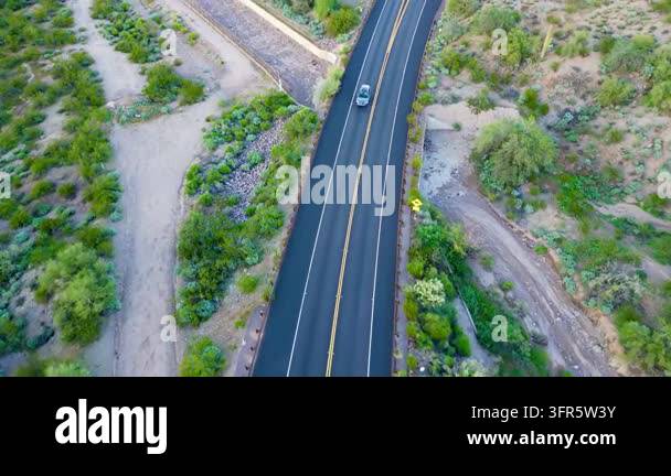 Aerial top view of a car driving on a rural asphalt road Stock Video ...