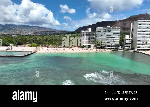 Aerial drone footage of a crowded beach with high-rise hotels and ...