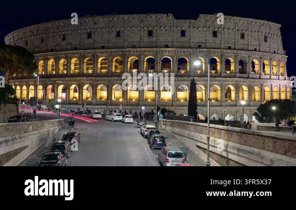 10.02.2026 Italy, Lazio, Rome, Colosseum in Rome during the night. Cars ...