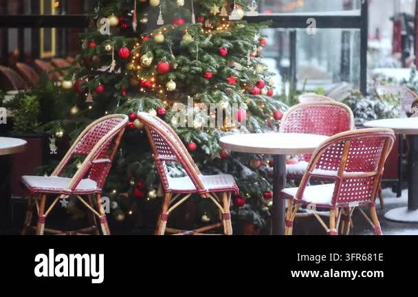 Cozy Parisian cafe terrace with red rattan chairs and round tables ...