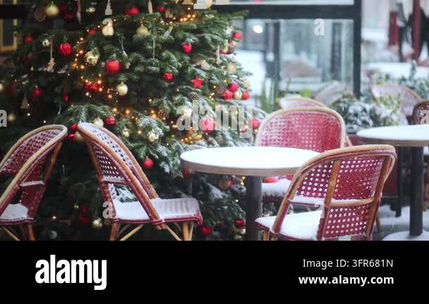 Cozy Parisian cafe terrace with red rattan chairs and round tables ...