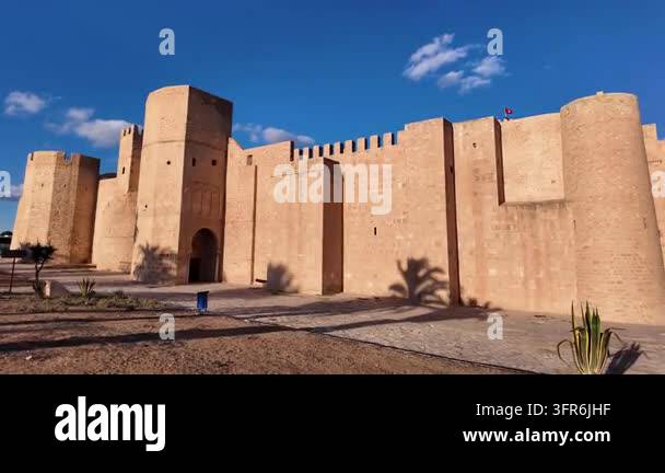 Large ancient stone fortress wall with round watchtower and battlements ...