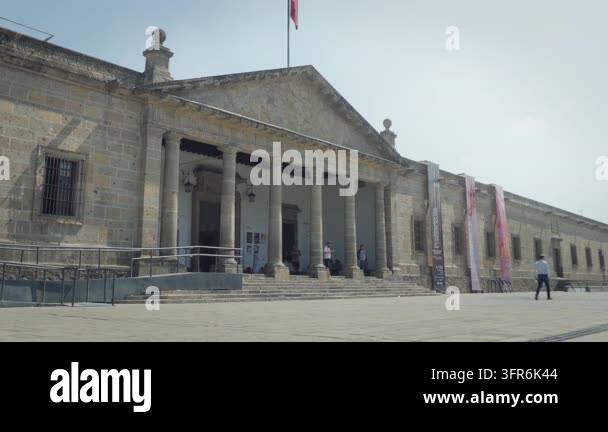 People walking past iconic entrance facade of Hospicio Cabanas landmark ...