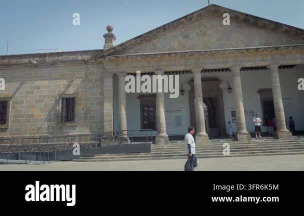 People walking past iconic entrance facade of Hospicio Cabanas landmark ...