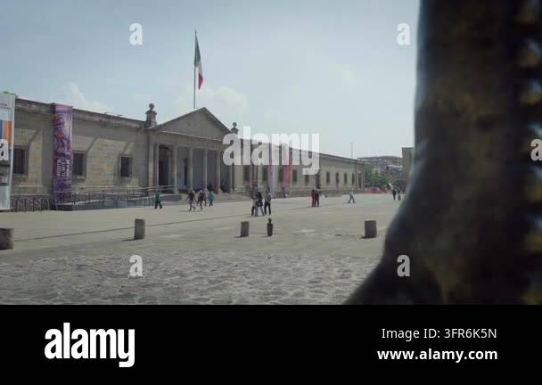 People walking past iconic entrance facade of Hospicio Cabanas landmark ...