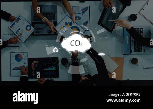 A diverse business team collaborates on carbon emission reduction ...