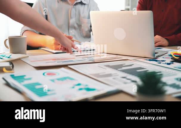 A diverse business team engages in a productive meeting, discussing ...
