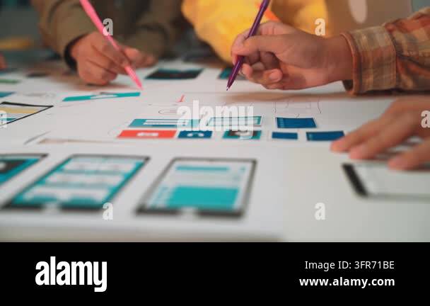 A diverse team collaborates in a modern workspace, using colorful pens ...