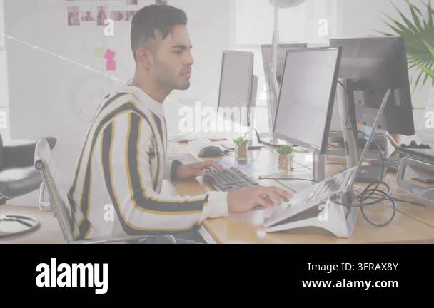Asian worker sitting at desk, typing, thinking with network icons ...