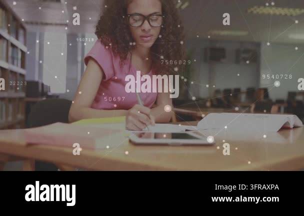 Woman studying with book and tablet while digital data nodes appearing ...