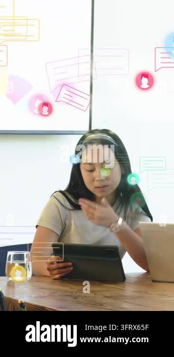 Vertical video: Woman reading tablet, standing to lead tech demo ...