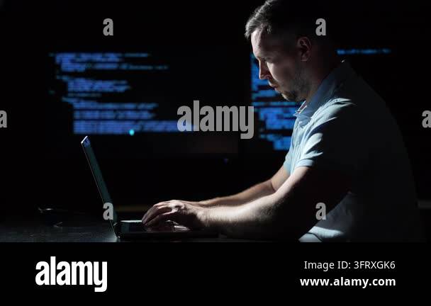 Programmer coding on a laptop computer. Programmer working with code on ...