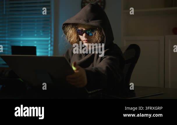 Night hacker child working on computer. Hooded hacker kid in cyber ...