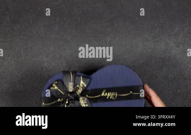 blue heart-shaped gift box with silver ribbon tied in a bow Stock Video ...