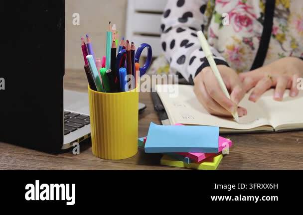 Woman Writing on Paper Surrounded by Colorful Notes and a Coffee Mug ...
