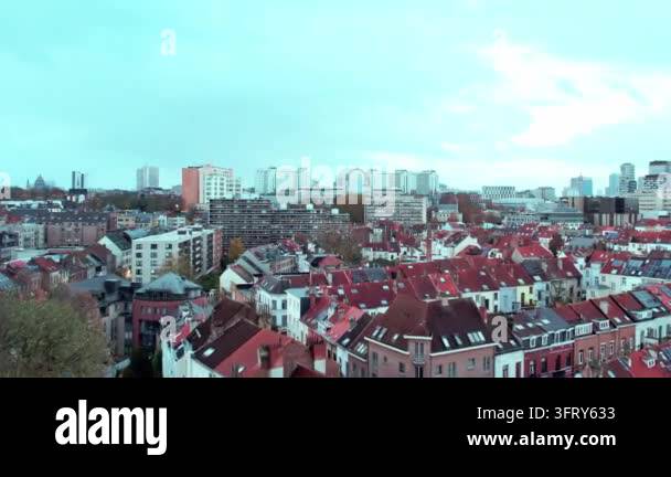 Aerial view of urban rooftops with modern buildings in the background ...