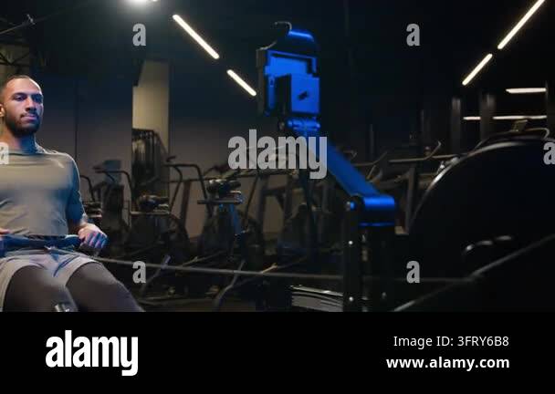 African American ethnic man male athlete cable machine workout in gym ...