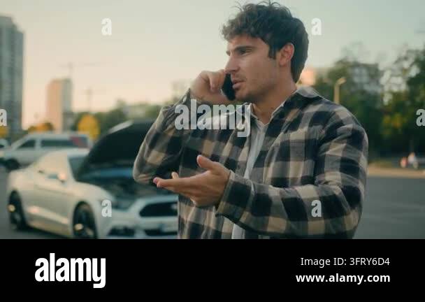 Stressed Caucasian man driver calling auto assistance service beside ...