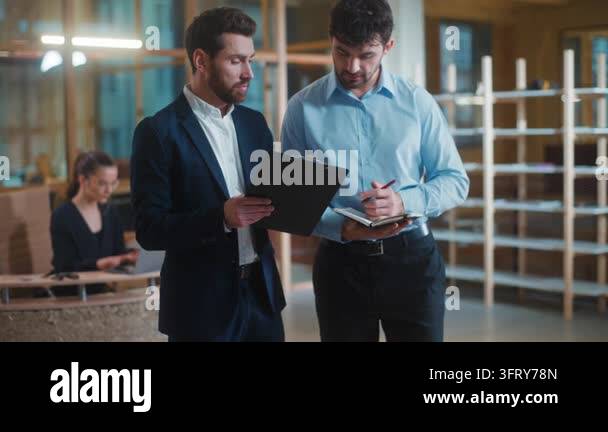 Two Caucasian men businessmen colleagues working together with business ...