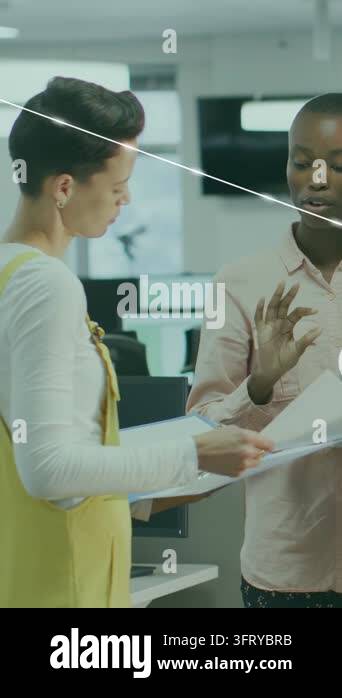 Vertical video: Two women holding file forth aligning tech plan growing ...