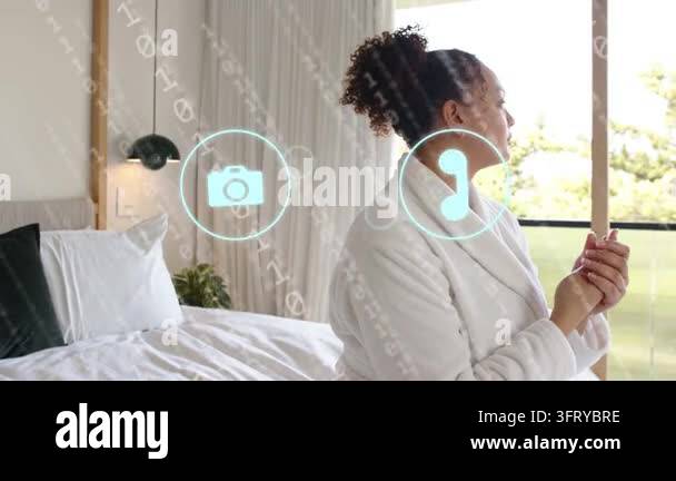 Woman sitting on bed tapping floating AR icons, selecting phone and ...