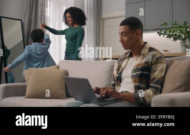 Happy African American family mother father little boy dancing in ...