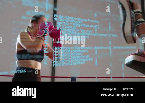 Female boxer doing front kick, punching coach pads, training while blue ...