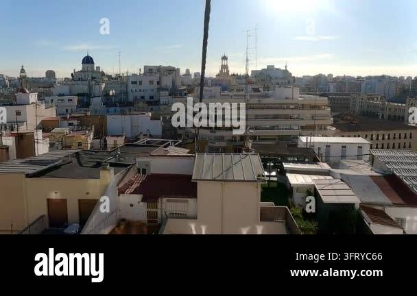 Cityscape view of buildings and rooftops under a bright blue sky during ...