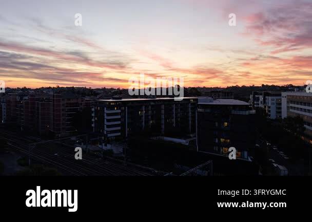 Colorful sunset over buildings and rooftops Stock Video Footage - Alamy