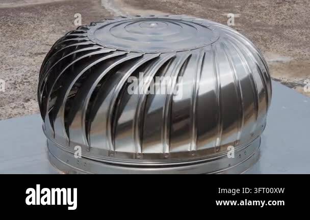 The stainless steel turbine hood on the roof rotates at a constant ...