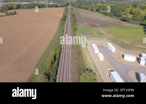 A drone push in forward movement above a straight express train line in ...