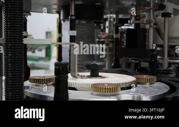 Close-up of mechanical components and rotating gears on an automated ...