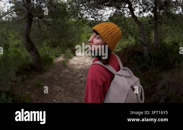 A beautiful young, happy adult girl was hiking with a backpack in the ...