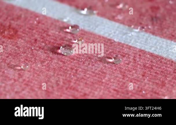 Surface Texture Graphics Small rounded water droplets gathered across a textured carpet surface ...