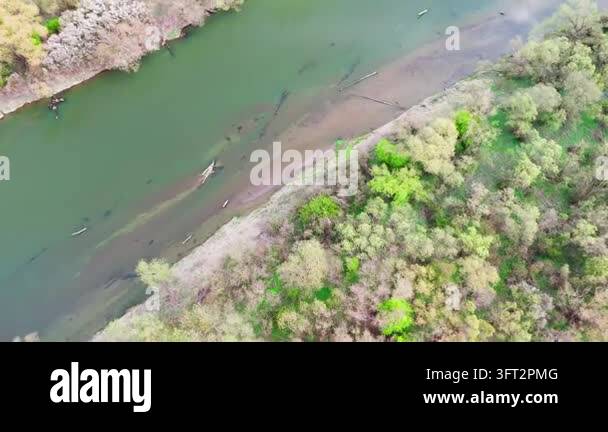 Aerial Spring Pale sandbar stretching under clear shallow river water, with a few ...