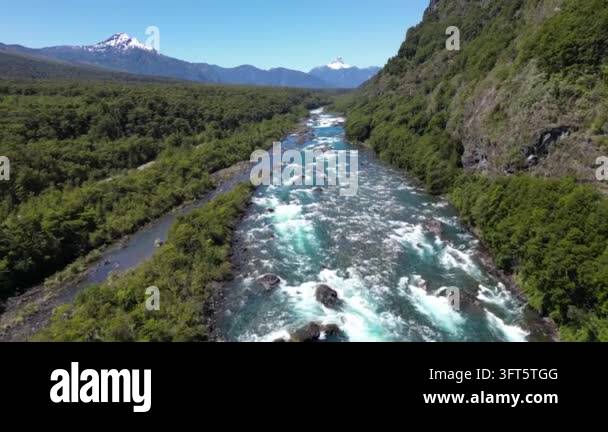 Fast Flowing Rivwer Aerial drone footage flying over a wide, fast-flowing river with white ...