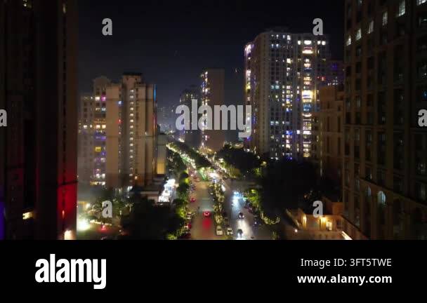 Aerial view of a busy city street at night with traffic and illuminated ...