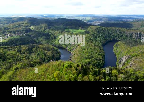 Winding Riger Aerial drone footage captures a winding river through lush green ...