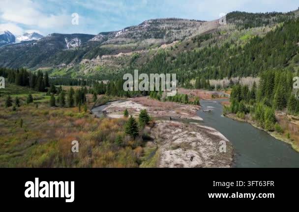 Winding Riger Aerial drone footage captures a winding river flowing through a lush ...