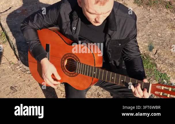 String Instruments Hd Close up hands of artist plays wooden acoustic guitar in autumnal park ...