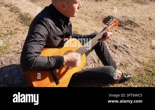 String Instruments Hd Portrait of smiling caucasian artist plays wooden acoustic guitar in ...