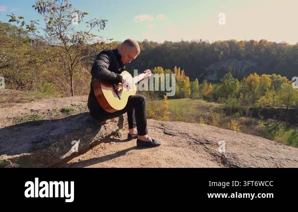 String Instruments Hd Portrait of smiling caucasian artist plays wooden acoustic guitar in ...