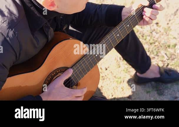 String Instruments Hd Close up hands of artist plays wooden acoustic guitar in autumnal park ...
